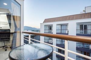 a balcony with a table and a view of a building at Hua Hin Condo D - Maysa & Hin Nam in Hua Hin