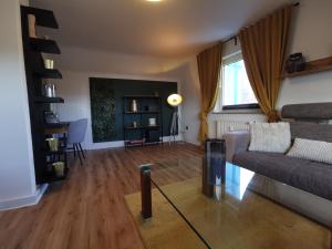 a living room with a couch and a table at Moderne Ferienwohnung Iserlohn 1 in Iserlohn