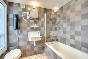 a bathroom with a toilet and a sink at WIT Hotel in Paris