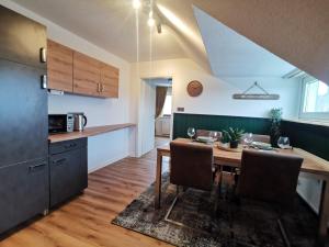 a kitchen and dining room with a table and chairs at Moderne Ferienwohnung Iserlohn 1 in Iserlohn