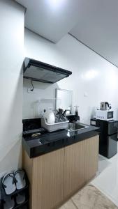 a kitchen with a sink and a counter top at Comfortable Studio Stay Made for Relaxation in Iloilo City