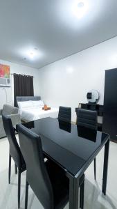 a dining room with a table and chairs and a bed at Comfortable Studio Stay Made for Relaxation in Iloilo City