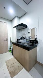 a kitchen with a sink and a counter top at Comfortable Studio Stay Made for Relaxation in Iloilo City