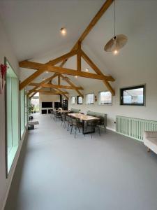 a room with tables and chairs in a building at Treeline Cabins in Cădăreşti
