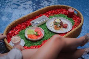 a model of a table with food in a pool at La Tano's Canggu in Canggu