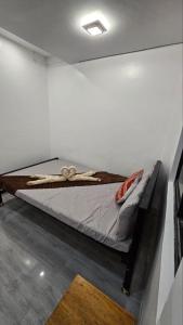 a bed in a white room with at Fab's Spot El Nido in El Nido