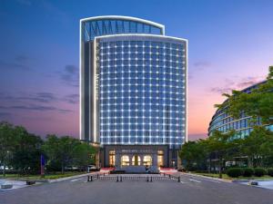 a tall building with a lot of windows at Mercure Luoyang Downtown in Luoyang