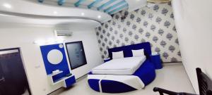 a small room with a bed and a tv at Hotel Grace Inn Multan in Multan +68 photos