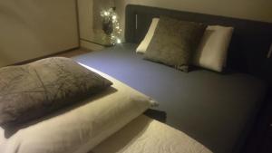 a bed with two pillows on it in a bedroom at K82 BNB & Hotel in Kirchentellinsfurt