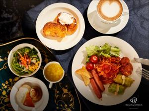 a table with plates of food and a cup of coffee at Daiwa Roynet Hotel Yokohama-Koen in Yokohama
