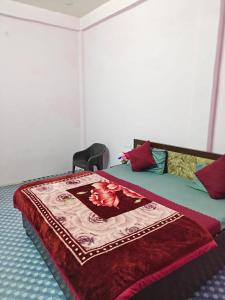 a bedroom with a bed with a blanket on it at Shri Prabhu guest house in Ayodhya