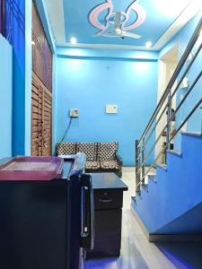 a room with a staircase with blue walls and a ceiling at Shri Prabhu guest house in Ayodhya