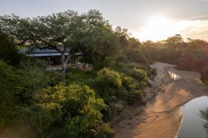 an aerial view of a house next to a river at Nomads Den Safari Villas - Heated Pools and Riverbed views in Hoedspruit