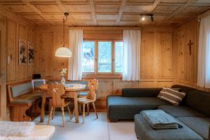 a living room with a couch and a table at Haus Buachwald in Schruns