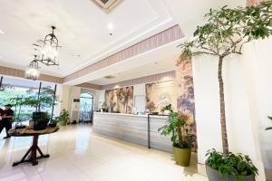 a lobby with potted plants in a building at Mella Hotel Manila near NAIA Airport in Manila +173 photos