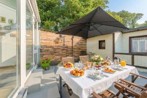 a table with food and an umbrella on a patio at Ferienhaus Ingrid in Heringsdorf