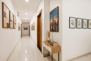 a hallway with paintings on the walls and a table at FabHotel Apple Near ITI in Indore
