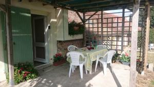 a table and chairs sitting on a patio at Le Poirier Perfect for 2 adults and 2 children Heated Pool and Games Room in Auverse