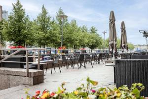 a row of tables and chairs with umbrellas at Scandic Grand Marina in Helsinki