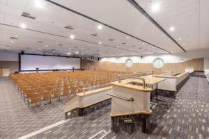 an empty lecture hall with chairs and a projection screen at Scandic Grand Marina in Helsinki