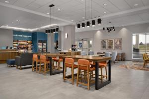 a waiting room with tables and chairs in a store at Hampton Inn By Hilton Dexter in Dexter