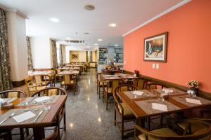 a dining room with wooden tables and chairs at Hotel OK in Rio de Janeiro