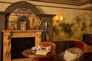 a living room with a fireplace and a table and chairs at Wonder - The Luxury Boutique Hotel in Budapest +38 photos