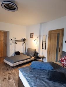 two beds sitting in a room with at Apartmány Kunčice in Staré Město