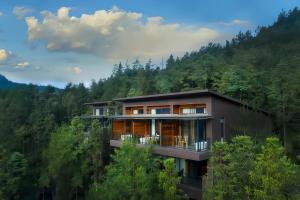 a house in the middle of a forest at ZhangJiaJie Peak&Creek Resort-Free Infinity Pool-Near the Ticket Gate-Stream Exploration Experience in Zhangjiajie