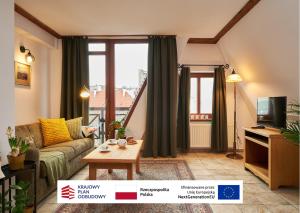 a living room with a couch and a tv at Vincent OldTown Apartments in Wrocław