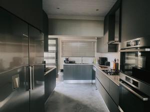 a kitchen with black cabinets and a counter top at Dolphin View Accomodation in Strandfontein