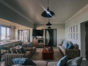 a living room with two couches and a table at Dolphin View Accomodation in Strandfontein