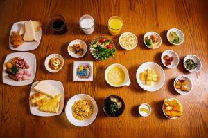 a wooden table with plates of food on it at S-Presso Namba Parks Street in Osaka +47 photos