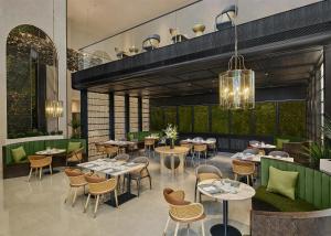 a restaurant with tables and chairs in a room at Doubletree By Hilton Shenzhen Bay in Shenzhen