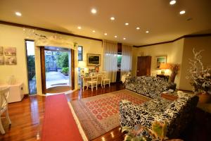 a living room with couches and a dining room with a table at B&B Villa Bianca in Sona