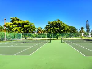 a tennis court with two tennis rackets on it at Caloosa Cove Resort - With Full Kitchens in Islamorada