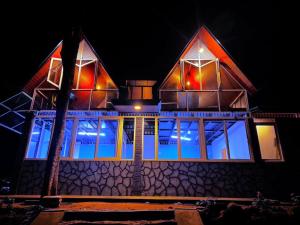 a house lit up at night with lights at Sandungira Eco Resort in Belihuloya