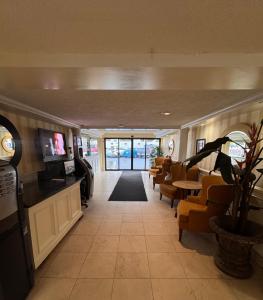 a lobby with a waiting room with chairs and tables at Island Travel Inn in Victoria