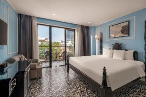 a bedroom with a large bed and a balcony at Hotel Del Luna Boutique in Danang +153 photos