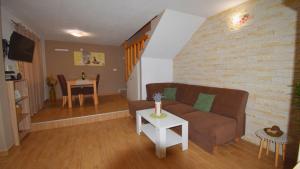 a living room with a couch and a table at Coastal Retreat Villa Milena by Villas Guide in Novalja