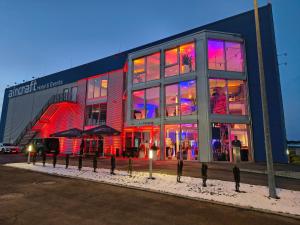 a large building with lights in the windows at Aircraft Hotel & Events in Neuhausen ob Eck