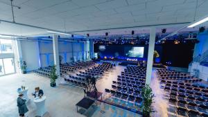 an auditorium with rows of chairs and a stage at Aircraft Hotel & Events in Neuhausen ob Eck
