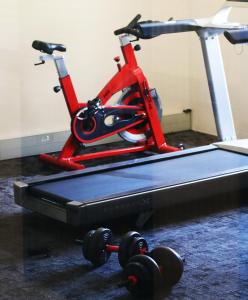 a red bike with wheels on a treadmill at Hampshire Hotel - Ballito in Ballito