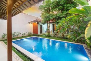 a swimming pool in the backyard of a house at Villa Omah Rindu in Yogyakarta