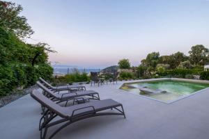 a group of chairs sitting next to a swimming pool at Vista by Del Sol Villa in Rhodes Town +46 photos
