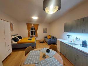 a kitchen and living room with a couch and a table at Vocell in Kutná Hora