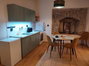 a kitchen with a table and a kitchen with a table and chairs at Vocell in Kutná Hora +10 photos