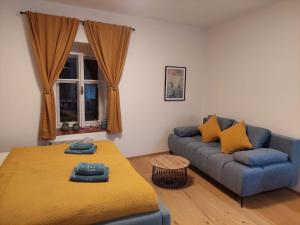 a living room with a bed and a couch at Vocell in Kutná Hora