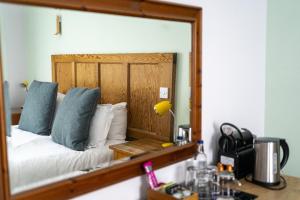 a mirror reflection of a bed in a room at The Old Cannon Brewery in Bury Saint Edmunds