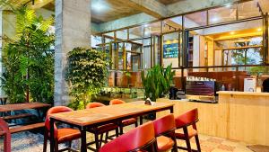 a restaurant with a wooden table and chairs at Privee Dhaka - PRIVEE RESORT & RESTAURANT in Bholānāthpur